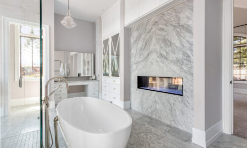 Master bathroom with bathtub and fireplace